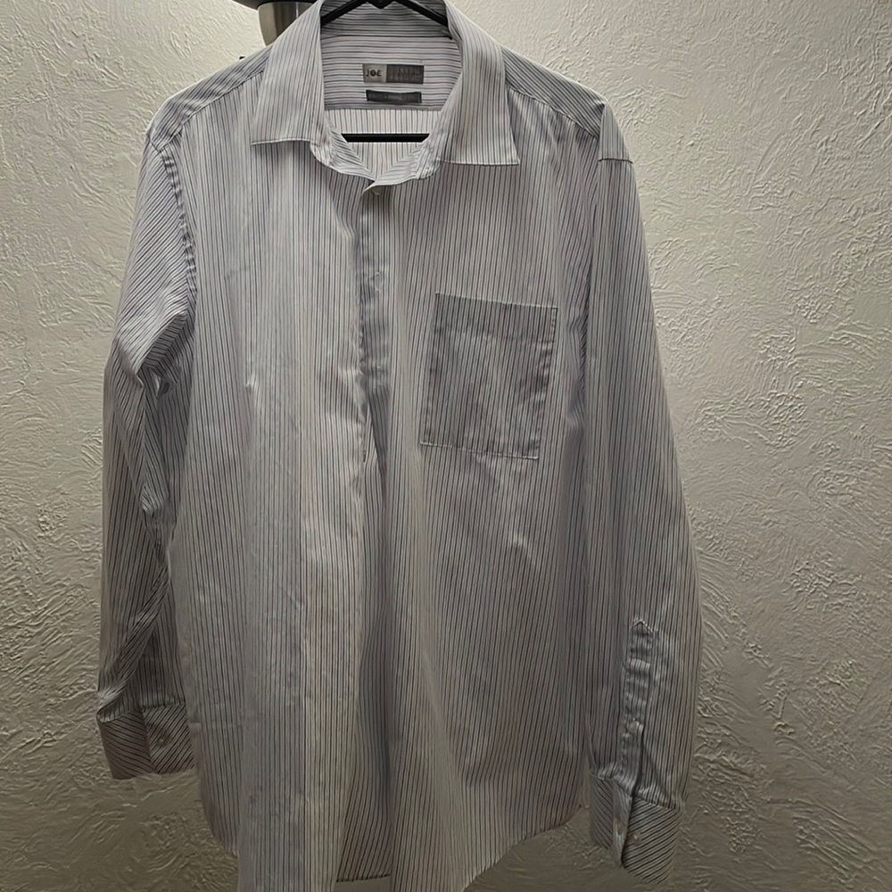 White with light blue pen stripes. Slim fit. Wrinkle free.
